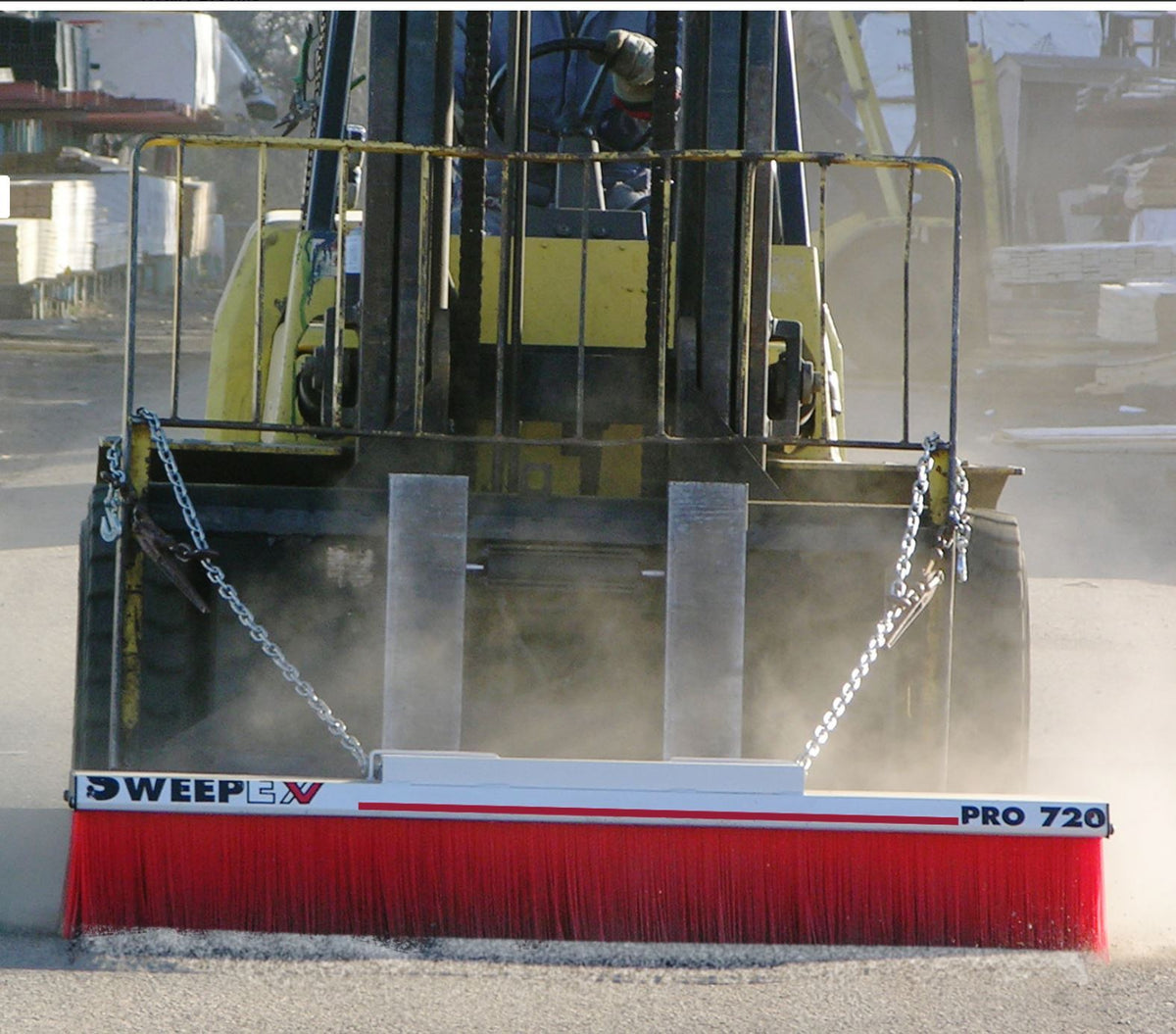 SweepEx forklift broom clearing a jobsite
