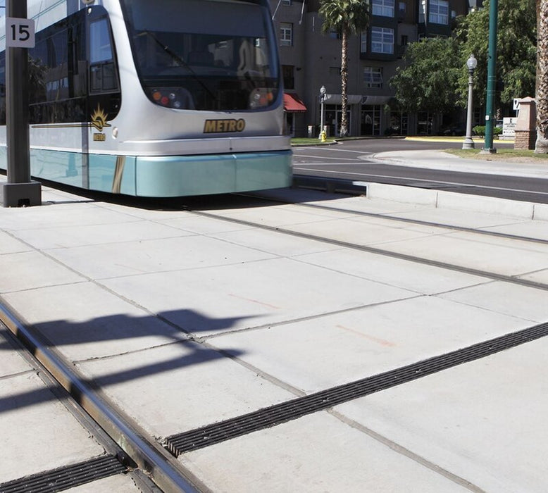 ACO K100 channel drain along a light rail platform
