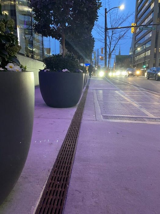 ACO KlassikDrain K100 trench drain installed in a sidewalk
