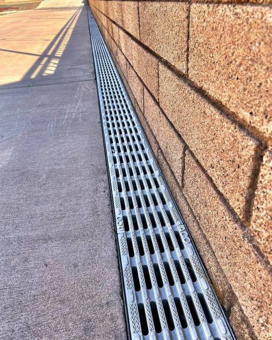 ACO K100 trench drain with a plastic grate
