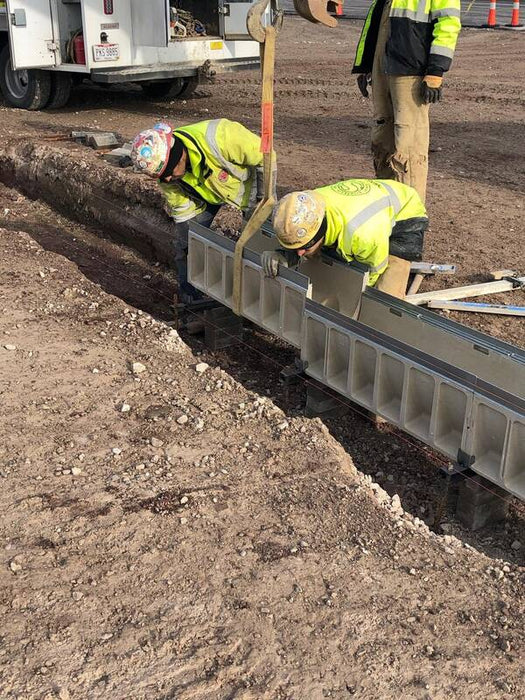 ACO K300 channel drain sections set in a trench during installation
