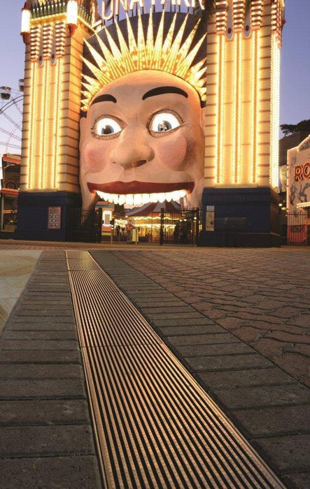 ACO K300 slot-grate trench drain across a paved plaza
