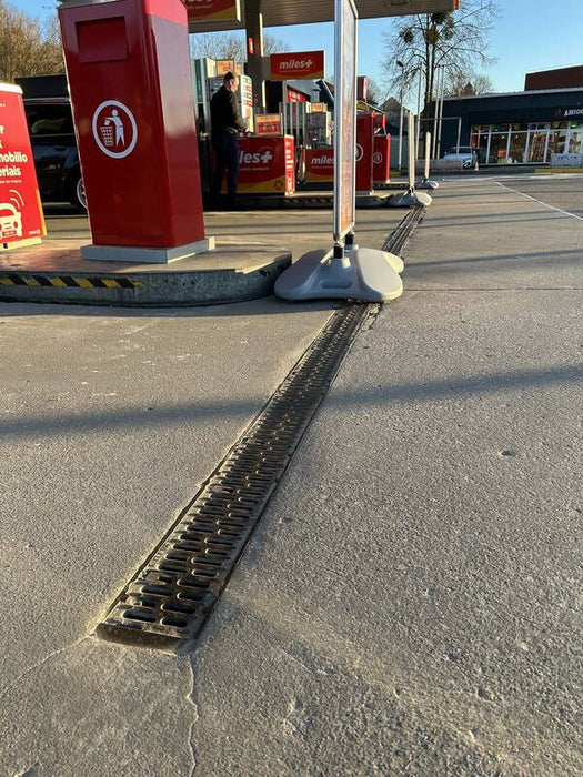ACO PowerDrain S100K channel drain across a gas station forecourt
