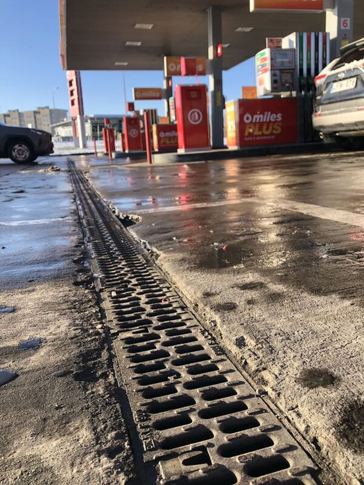 ACO PowerDrain S100K channel drain at a fuel station forecourt
