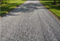 Completed residential gravel driveway stabilized with geotextile fabric
