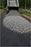 Dumping gravel over woven geotextile fabric on a driveway
