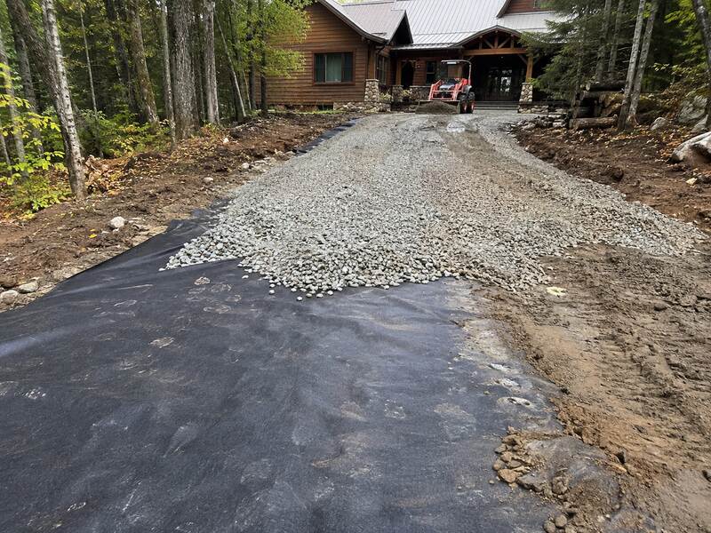 Gravel driveway built over woven geotextile fabric
