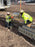 Workers installing ACO K300 channel drain sections at a jobsite
