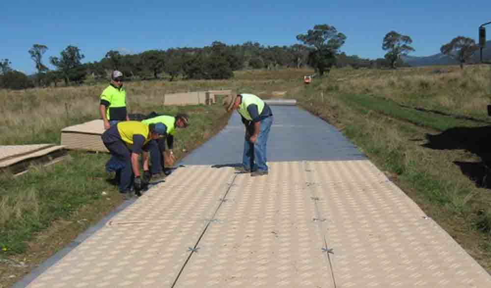 Workers connecting Duradeck mats
