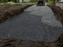 Spreading gravel on non-woven fabric