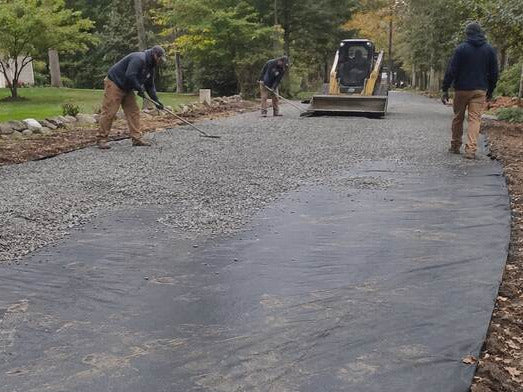 Woven driveway stabilization fabric during a gravel install
