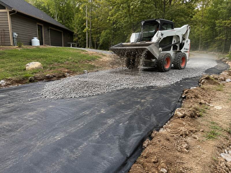 Woven geotextile stabilization fabric under gravel on a driveway

